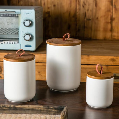JOJUNO White Ceramic Canister Set with Wooden Lid, 3-Piece Airtight Food Storage Jars for Kitchen Counter - Flour, Sugar, Coffee, Tea, Spice - Small, Medium, Large Sizes